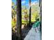 Outdoor patio with peaceful views of the community landscaping, seating, and nearby palm trees at 1515 Forrest Nelson Blvd # P107, Port Charlotte, FL 33952