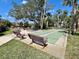Outdoor shuffleboard area with benches and picnic tables offers residents recreational space at 1515 Forrest Nelson Blvd # P107, Port Charlotte, FL 33952