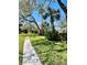 Scenic community walkway lined with mature trees and lush landscaping offers a peaceful stroll at 1515 Forrest Nelson Blvd # P107, Port Charlotte, FL 33952