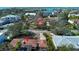 Stunning aerial view of a waterfront home with lush landscaping and beautiful surroundings at 1555 Flower Dr, Sarasota, FL 34239