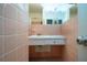Bathroom featuring pink tile and a vanity at 1555 Flower Dr, Sarasota, FL 34239