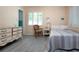 Bedroom featuring light gray flooring, neutral walls, white-shuttered windows, and white dresser at 1555 Flower Dr, Sarasota, FL 34239