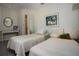 Bedroom featuring neutral walls, light gray flooring, and twin beds at 1555 Flower Dr, Sarasota, FL 34239