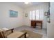 The bedroom features a desk, a window, and a decorative painting at 1555 Flower Dr, Sarasota, FL 34239