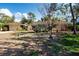 Inviting single-story home featuring terracotta tile roof and mature landscaping at 1555 Flower Dr, Sarasota, FL 34239