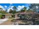 Lovely single-story home with a terracotta tile roof and mature landscaping at 1555 Flower Dr, Sarasota, FL 34239