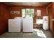 Functional laundry room featuring a washer, dryer, sink and hot water tank at 1555 Flower Dr, Sarasota, FL 34239