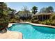 A stunning pool with a landscaped backyard and luxurious outdoor living at 1555 Flower Dr, Sarasota, FL 34239