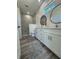 Bright bathroom featuring double sinks, modern fixtures, a walk-in shower, and a large window at 18290 Grace Ave, Port Charlotte, FL 33948