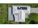 Aerial view of house showing roof with solar panels and paver patio at 217 Giotto Dr, Nokomis, FL 34275