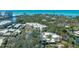 Aerial view of community showcasing lush landscaping, waterways, and proximity to the beach at 231 Hourglass Way # V5, Sarasota, FL 34242