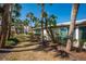 Home exterior showcasing backyard with lush tropical landscaping at 231 Hourglass Way # V5, Sarasota, FL 34242