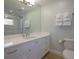 Clean bathroom with a white vanity, modern fixtures, a glass-enclosed shower, and ample lighting at 231 Hourglass Way # V5, Sarasota, FL 34242