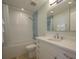 Stylish bathroom featuring blue accent tiles, a modern vanity with a sink, and a shower-tub combo at 231 Hourglass Way # V5, Sarasota, FL 34242