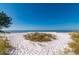 Scenic beach view with white sand, clear blue sky, and tranquil ocean waters at 231 Hourglass Way # V5, Sarasota, FL 34242