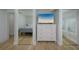 Bedroom showing mirrored closet doors, closet door with shutter and TV over white dresser at 231 Hourglass Way # V5, Sarasota, FL 34242