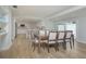 Open-concept dining room with a view into the modern kitchen and adjacent seating at 231 Hourglass Way # V5, Sarasota, FL 34242