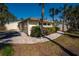 Well-maintained home exterior with lush landscaping, charming walkway and a two car garage at 231 Hourglass Way # V5, Sarasota, FL 34242