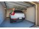 Clean, well-lit garage featuring epoxy flooring, ample storage space, and a modern vehicle at 231 Hourglass Way # V5, Sarasota, FL 34242