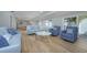 Open living space with stylish furnishings, a view of the kitchen, and sliding glass doors to the backyard at 231 Hourglass Way # V5, Sarasota, FL 34242