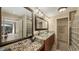 Beautiful bathroom with granite counters, glass bowl sinks, decorative mirrors, and a walk-in shower at 2416 Webber St, Sarasota, FL 34239