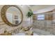 Bathroom with a granite vanity, decorative mirror, and a tiled shower/tub combo at 2416 Webber St, Sarasota, FL 34239