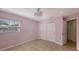 Charming bedroom with pink walls, tile floors, a chandelier, and a closet for storage at 2416 Webber St, Sarasota, FL 34239