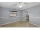 Cozy bedroom with neutral paint, tile floors, a ceiling fan, and plenty of natural light at 2416 Webber St, Sarasota, FL 34239