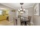 Bright dining room featuring neutral wall colors, tile floors, seating for four, and adjacent kitchen access at 2416 Webber St, Sarasota, FL 34239