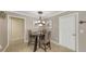 Cozy dining area featuring a modern chandelier, neutral wall colors, tile floors, and seating for four at 2416 Webber St, Sarasota, FL 34239