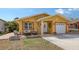 Inviting home exterior featuring a cozy seating area, well-maintained lawn, and a charming yellow facade at 2416 Webber St, Sarasota, FL 34239