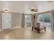Comfortable living room with neutral colors, tile floors, a ceiling fan, and views of the backyard at 2416 Webber St, Sarasota, FL 34239