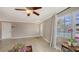 Bright living room featuring neutral paint, a ceiling fan, tile flooring, and a large window for ample natural light at 2416 Webber St, Sarasota, FL 34239