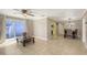 Open-concept living room and dining area with tile floors, a ceiling fan, and a sliding glass door to the patio at 2416 Webber St, Sarasota, FL 34239