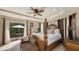Luxurious main bedroom with a four-poster bed, sitting area, and access to a private patio at 2416 Webber St, Sarasota, FL 34239