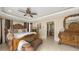 Elegant main bedroom with a decorative four-poster bed, sitting area, and access to the ensuite bathroom at 2416 Webber St, Sarasota, FL 34239