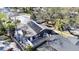 Aerial view of home featuring solar panels, fenced yard, and outdoor dining area at 2900 Woodpine Ct, Sarasota, FL 34231