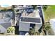 Overhead view of a house reveals solar panels, fenced yard, and swimming pool in the neighborhood at 2900 Woodpine Ct, Sarasota, FL 34231