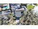 This property features solar panels, a fenced yard, and is surrounded by mature trees and lush landscaping at 2900 Woodpine Ct, Sarasota, FL 34231
