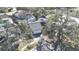 Aerial view of a landscaped property with a mature trees, and a two-car garage at 2900 Woodpine Ct, Sarasota, FL 34231
