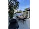 A backyard with a dining table and a barbecue grill at 2900 Woodpine Ct, Sarasota, FL 34231