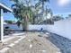 Landscaped backyard with a gravel area, fire pit, and dining table, perfect for outdoor entertaining and relaxation at 2900 Woodpine Ct, Sarasota, FL 34231