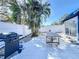 A fenced backyard with a palm tree, pavers, a dining table, and a grill at 2900 Woodpine Ct, Sarasota, FL 34231