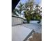 Spacious backyard with a patio, gravel area, and privacy fence, offering ample space for outdoor activities at 2900 Woodpine Ct, Sarasota, FL 34231