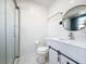 Bathroom featuring a shower, toilet, vanity with sink, and round mirror at 2900 Woodpine Ct, Sarasota, FL 34231