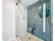 Updated bathroom featuring glass shower with pebble floor and decorative tile accent wall and recessed shelf at 2900 Woodpine Ct, Sarasota, FL 34231