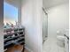 Contemporary bathroom with glass-enclosed shower and adjacent shoe storage at 2900 Woodpine Ct, Sarasota, FL 34231