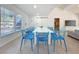 Dining area with a long table with seating, natural light, and sleek floors at 2900 Woodpine Ct, Sarasota, FL 34231