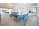 Open-concept living and dining area featuring modern furnishings, wood flooring, and high ceilings at 2900 Woodpine Ct, Sarasota, FL 34231