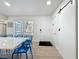 Bright dining room with large windows, a modern table setting, and stylish white interior at 2900 Woodpine Ct, Sarasota, FL 34231